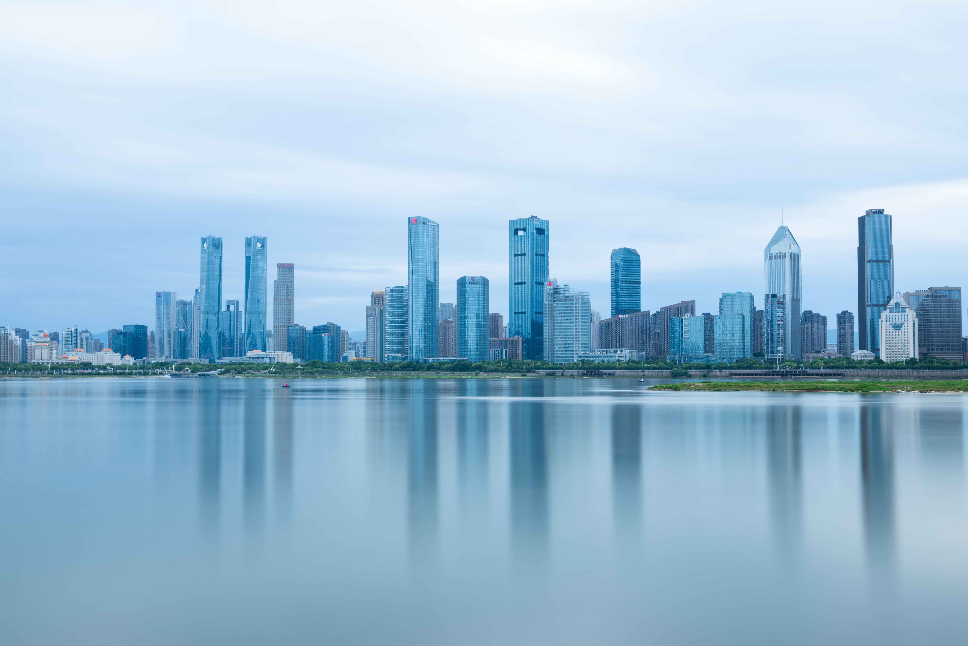 City skyline reflected in calm water, representing long-term vision